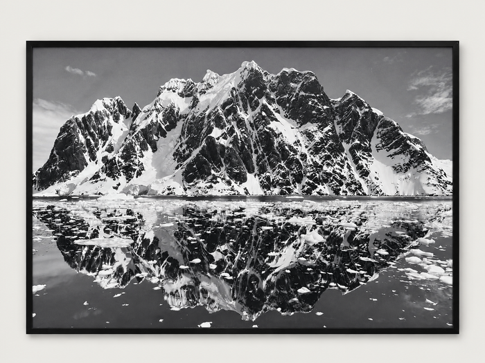 Black and white mountain reflection photograph in a black frame