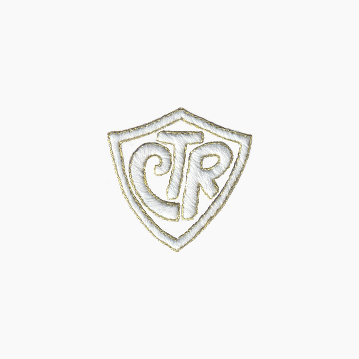 Hand embroidered cotton boutique tissue box cover of logo with 'CTR' inside a shield on a white background