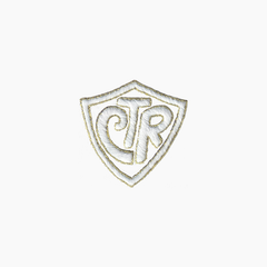 Hand embroidered cotton boutique tissue box cover of logo with 'CTR' inside a shield on a white background
