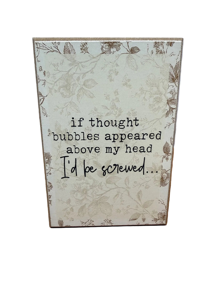Floral wood sign joking about thought bubbles
