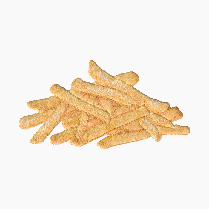Hand embroidered cotton towel with stack of golden-brown french fries on a white background