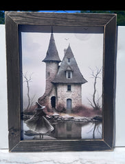 Framed print of a haunted house by a lake with a witch