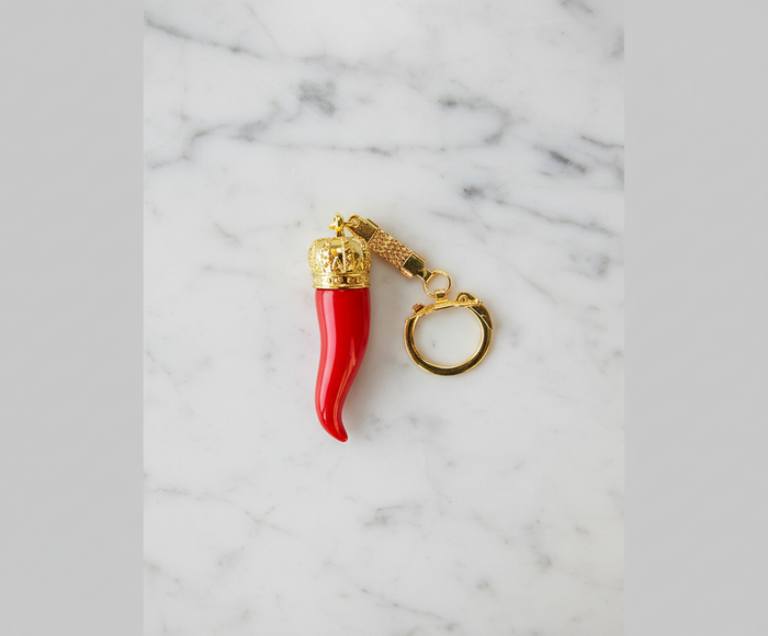 Red keychain with gold accents on a white background