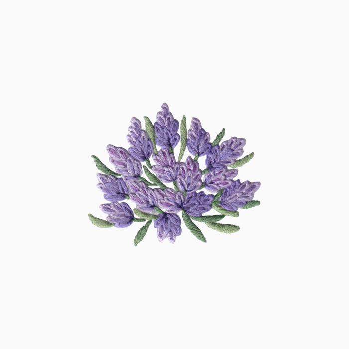 Hand embroidered cotton boutique tissue box cover of lavender flowers on a white background