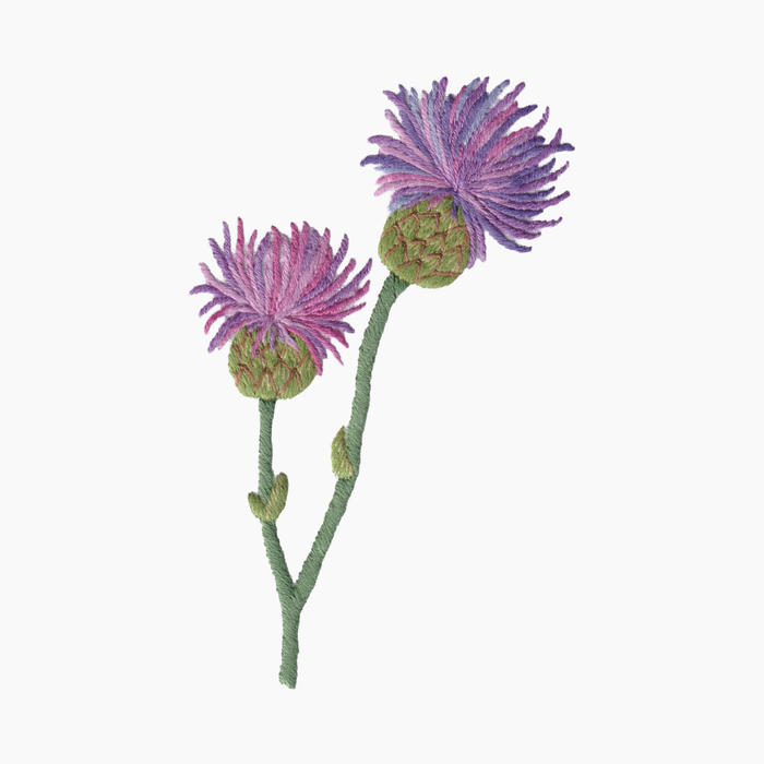 Hand embroidered cotton towel with two purple thistle flowers with green stems on a white background