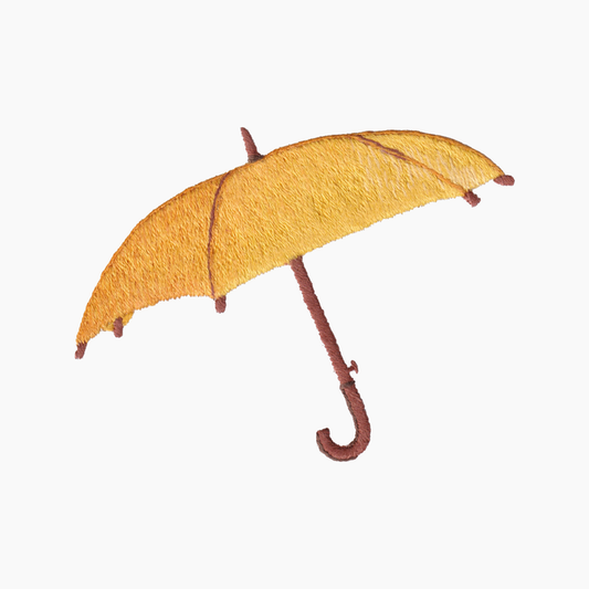 Hand embroidered cotton towel with yellow umbrella with a brown handle on a white background